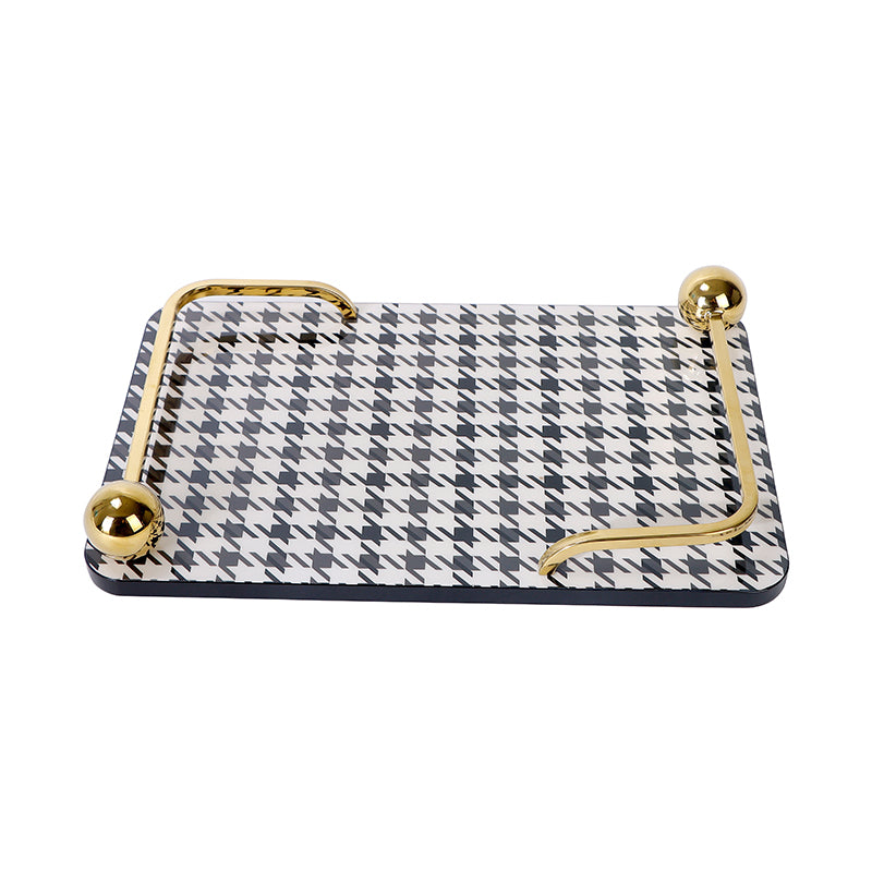 service tray with black and white houndstooth print and gold handels 